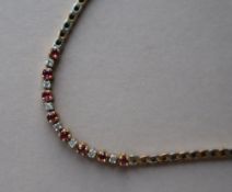 An 18ct yellow and white gold diamond and ruby bracelet,