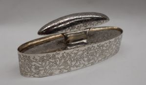 A Chinese silver desk ink blotter of oval form, line decorated with blossom trees,