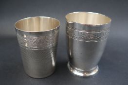 A French white metal beaker with engine turned decoration and anthemions,