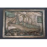 A bronze plaque / paperweight cast with an image of the RMS Lucania, "cast from metal from the ship,