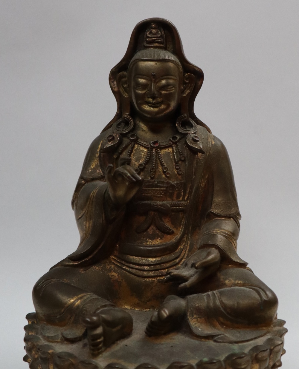 A Bronze figure of Quan yin, seated with right hand raised and left hand resting on her leg, - Image 7 of 9