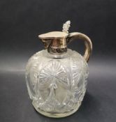 A Russian silver topped and cut glass jug, with hinged lid and leaf thumb piece,