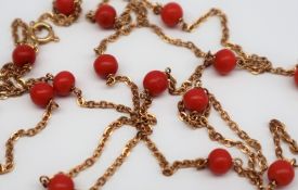 An 18ct yellow gold necklace set with coral beads, approximately 9.