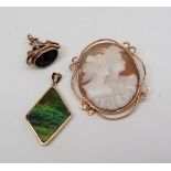 A 9ct yellow gold moss agate fob with a scrolling cage support together with a shell cameo brooch