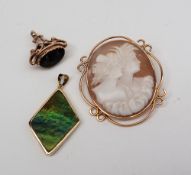 A 9ct yellow gold moss agate fob with a scrolling cage support together with a shell cameo brooch