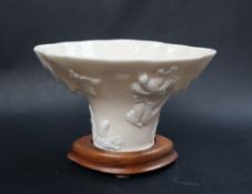 A Chinese blanc de chine or dehua porcelain libation cup, of rhinoceros horn form,