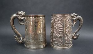 A Chinese silver tankard decorated with panels of birds, blossom trees, landscape scenes, etc,