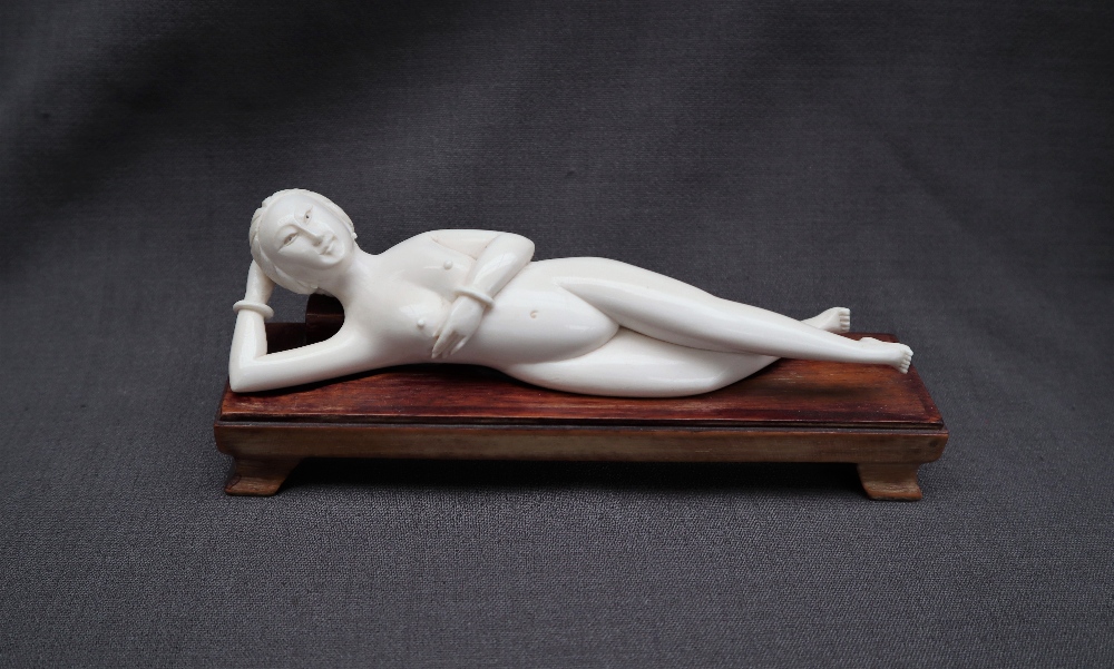 An early 20th century Japanese ivory erotica figure of a recumbent naked figure, 15.