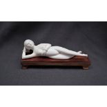 An early 20th century Japanese ivory erotica figure of a recumbent naked figure, 15.