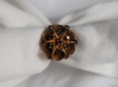 A 9ct yellow gold garnet set ring of floral form, set with seven garnets, size M, approximately 5.