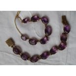 An amethyst set necklace, set with seven graduated oval faceted amethysts,