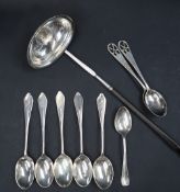 A white metal toddy ladle, of oval form, inset with a George III silver shilling dated 1787,