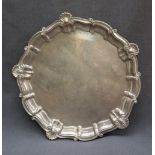 A silver salver, with a shell and scroll border on three tapering feet, Birmingham,