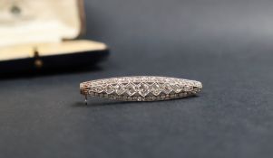 A diamond bar brooch of pointed oval form set with round old cut diamonds, 39mm long,