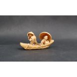A late 19th / early 20th century netsuke in the form of two figures in a boat, signed to the base,