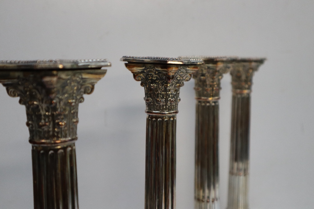 A set of four electroplated on copper Corinthian column candlesticks with stop fluted columns on a - Image 3 of 4
