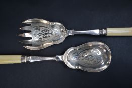 A pair of electroplated and faux ivory cased salad servers,