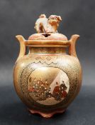 A Japanese satsuma pottery twin handled koro, the pierced cover with Dog of Foo surmount,