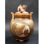 A Japanese satsuma pottery twin handled koro, the pierced cover with Dog of Foo surmount,