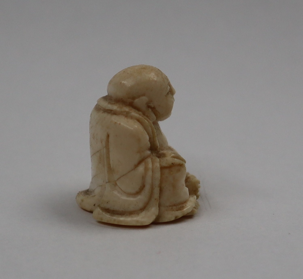 A late 19th / early 20th century ivory figure of Hotei, seated with his right hand on his knee, - Image 5 of 9