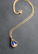 A lapis lazuli and diamond pendant of tear drop shape,