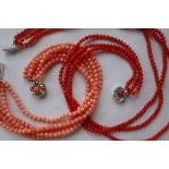 A three strand coral bead necklace to a white metal clasp,