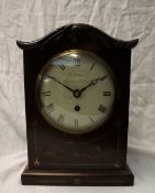 A Regency mahogany mantle clock, with an arched top and brass inlay,