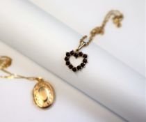 A 9ct gold Greenwich Meridian Millennium locket on a 9ct gold chain and a garnet set 9ct gold