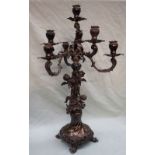 A continental white metal seven branch candleabra, the column decorated with winged cherubs,