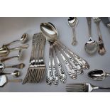 A set of six Danish silver table spoons, with foliate scrolling handles,