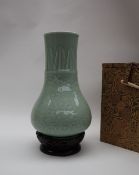 A Chinese celadon bottle vase, decorated with leaves and flowerheads,