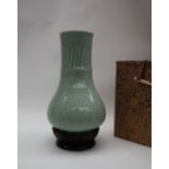 A Chinese celadon bottle vase, decorated with leaves and flowerheads,