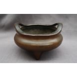 A Chinese bronze twin handled Koro, of squat circular form,