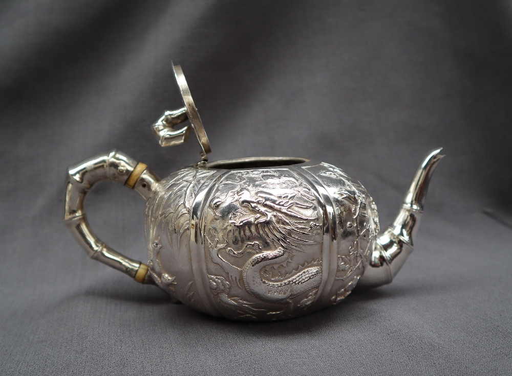A Chinese silver three piece teaset, comprising a teapot, cream jug and twin handled sugar basin, - Image 10 of 13