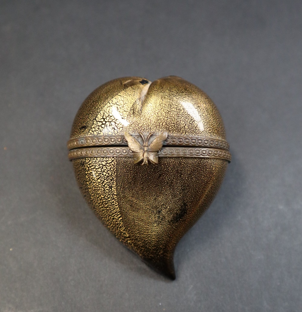 A gilt decorated black glass heart shaped box and cover,