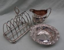 A late Victorian silver bon bon dish, with a scrolling flora; embossed border and pierced sides,