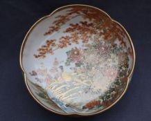 A Japanese satsuma pottery fruit bowl decorated with pheasants and chrysanthemums by a stream,