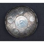 A Chinese white metal coin pin tray, inset with six Chinese coins,