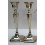 A pair of George V silver candlesticks,