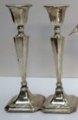 A pair of George V silver candlesticks,