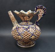 A Fischer Budapest reticulated pottery jug, decorated in blues, browns and turquoise,