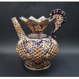 A Fischer Budapest reticulated pottery jug, decorated in blues, browns and turquoise,