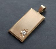 A 9ct yellow gold pendant ingot set with a round cut diamond, approximately 0.