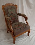 A Biedermeier style burr veneered library chair with a shaped back above scrolling arms and shaped