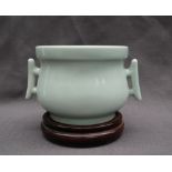 A Chinese celadon twin handled vase, of squat bulbous form with twin handles,