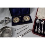 A pair of Late Victorian cased silver gilt open table salts of circular fork decorated with scrolls