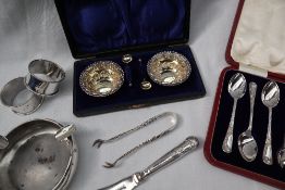 A pair of Late Victorian cased silver gilt open table salts of circular fork decorated with scrolls