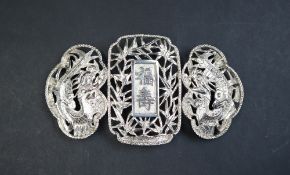 A Chinese silver belt buckle in three sections, pierced with dragons and bamboo, marked KC,