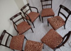 A set of eight Regency mahogany dining chairs with bar backs and stuff over seats on reeded