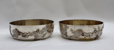 A pair of Chinese silver and gilt decorated bowls, decorated with blossom trees,